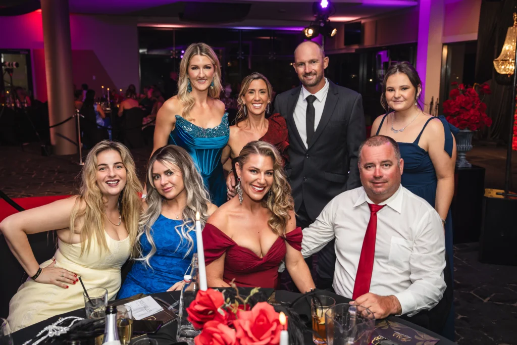 Guests in formal evening wear seated at tables during the Magnify Her Gala